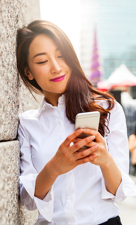South Korea – Young woman looking at her cell phone in South Korea.