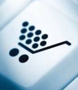 Fintech Insights – Close–up of a shopping cart graphic on a computer keyboard button.